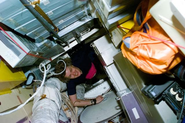 NASA image: Crewmember activity in shuttle middeck and Mir Space Station