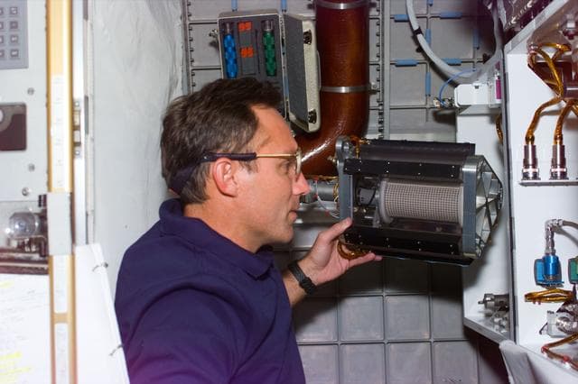 NASA image: MGM - Walz works with MGM experiment chamber