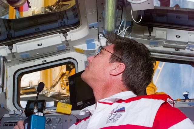 NASA image: Astronaut Blaha on aft flight deck in communication with Mir