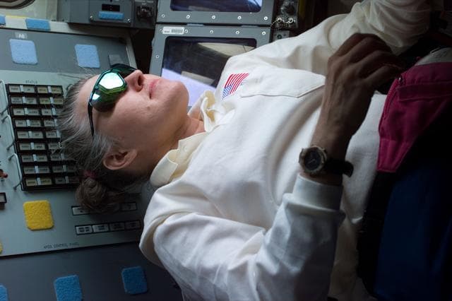 NASA image: Astronaut Lucid on flight deck with sunglasses