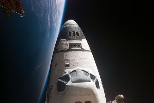 NASA image: View of orbiter nose and earth limb