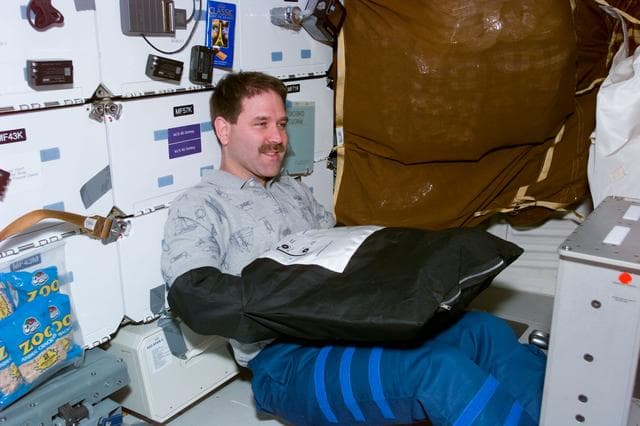 NASA image: MS Grunsfeld changes film using film bag
