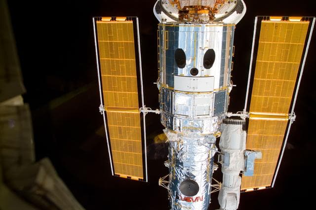 NASA image: HST,survey views of telescope after berthing