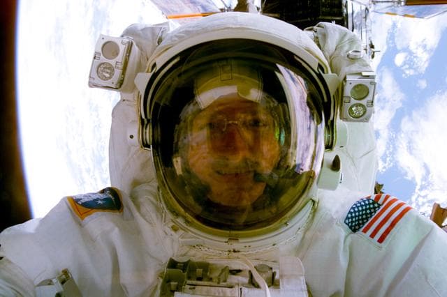 NASA image: Astronaut Joe Tanner comes up close to the aft flight deck window for a photo