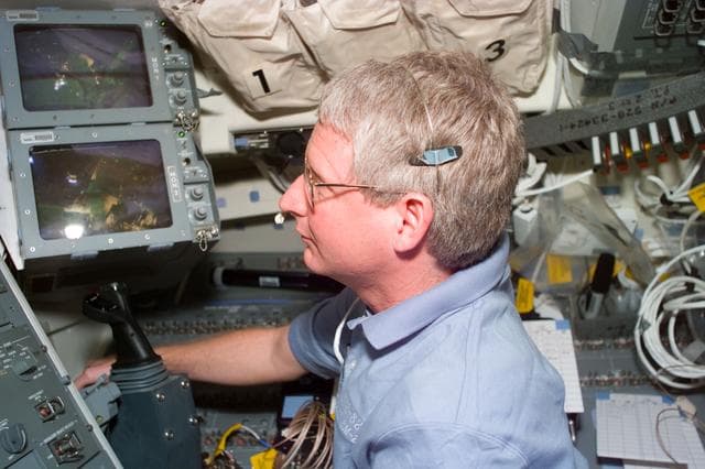 NASA image: Hawley controls the RMS arm from the flight deck during EVA on Flight Day 6