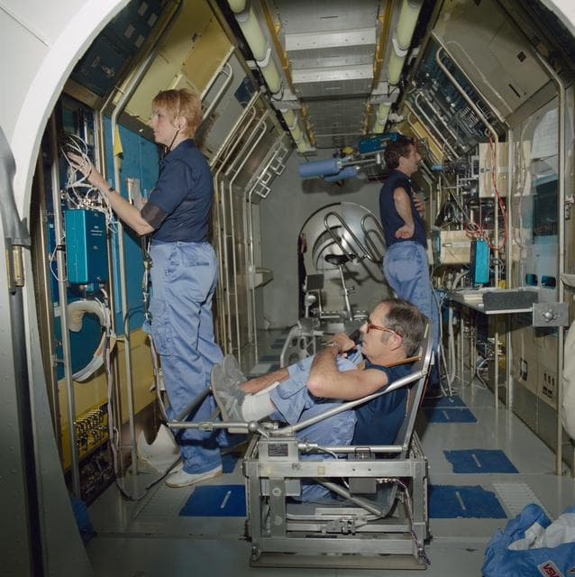 NASA image: SLS-1 crewmembers in high fidelity mockup of the Spacelab