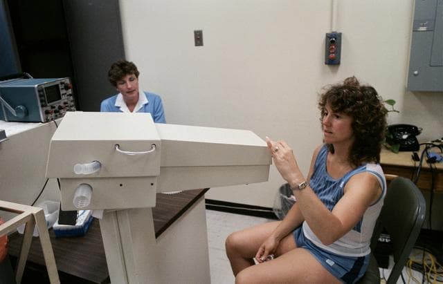 NASA image: Teacher Christa McAuliffe prepare to test her lung capacity