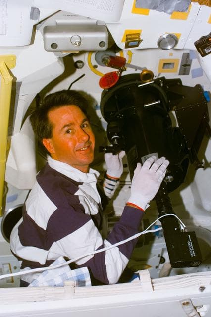 NASA image: SWUIS - Robinson works with telescope mounted in the side hatch window