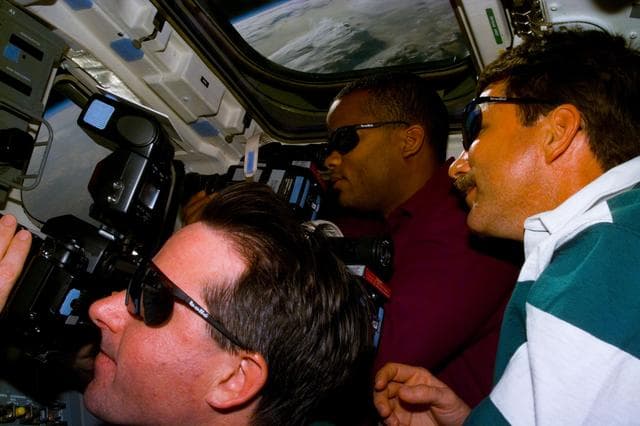 NASA image: MS Robinson,Curbeam and Plt Rominger take photographs out the aft FD windows