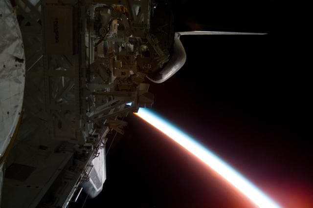 NASA image: Illuminated Earth limb edge with MFD experiment visible in payload bay