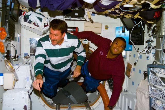 NASA image: Plt Rominger and MS Curbeam float in the middeck airlock hatch