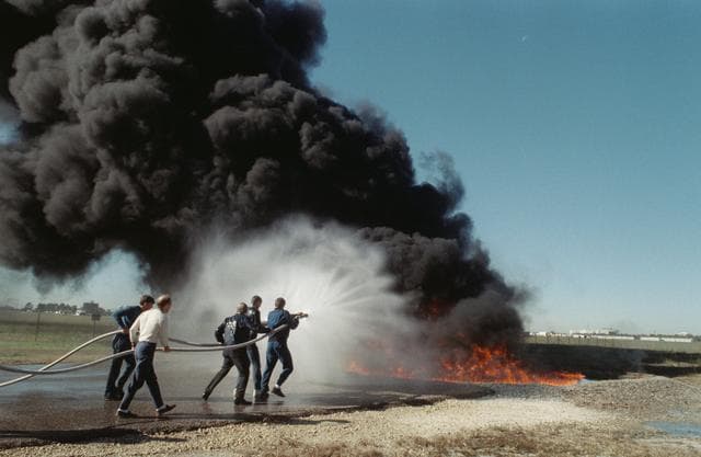 NASA image: STS-29 crewmembers participate in fire fighting training at JSC