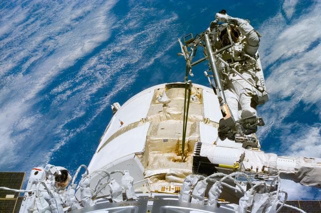 NASA image: Newman on RMS arm after deploying TORU antenna on FGB/Zarya module
