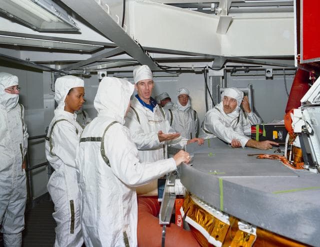 NASA image: STS-29 crewmembers inspect TDRS-D inertial upper stage (IUS) at KSC VPF