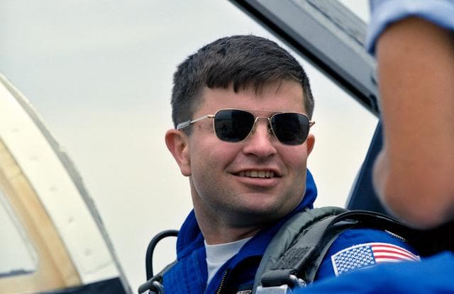 NASA image: Head and shoulders view of astronaut Ken Cameron sitting  in the cockpit