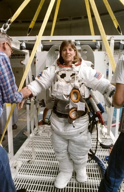 NASA image: STS-32 MS Dunbar dons EMU upper torso prior to WETF exercises