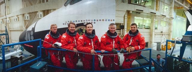 NASA image: STS-36 crewmembers in LESs pose in front of JSC's crew compartment trainer