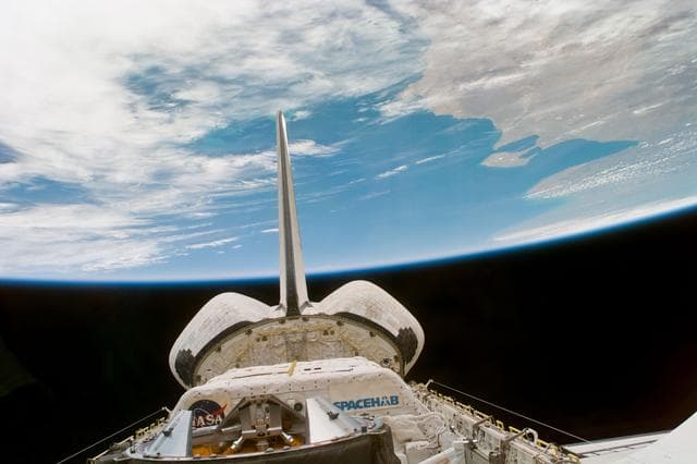 NASA image: Endeavour's payload bay and tail assembly under the Earth limb