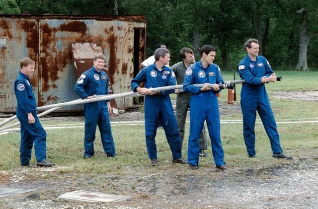 NASA image: STS-41 crewmembers participate in fire fighting exercises at JSC