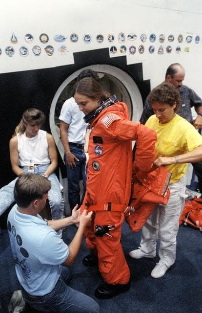 NASA image: STS-40 MS Jernigan dons LES parachute pack prior to egress training at JSC