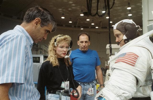 NASA image: STS-40 MS Jernigan in EMU listens as Pilot Gutierrez looks on in JSC's WETF