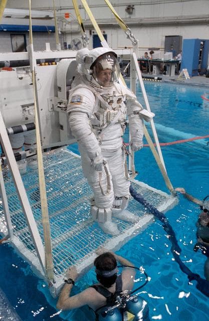 NASA image: STS-45 MS Foale in EMU is lowered into JSC's WETF pool for underwater test
