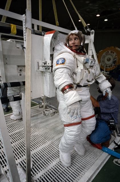 NASA image: STS-54 MS3 Susan J. Helms dons EMU for underwater simulation in JSC's WETF
