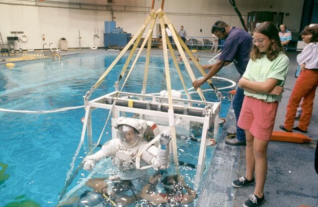 NASA image: STS-53 MS Voss, in EMU, in lowered into JSC's WETF pool for EVA simulation