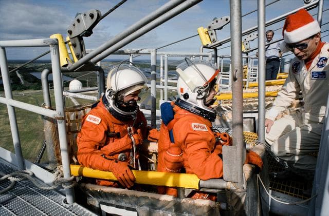NASA image: STS-54 MS2 Harbaugh and MS3 Helms during slidewire egress training at KSC