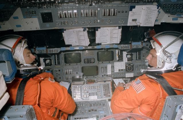 NASA image: STS-56 Commander Cameron & Pilot Oswald on CCT flight deck in JSC's MAIL