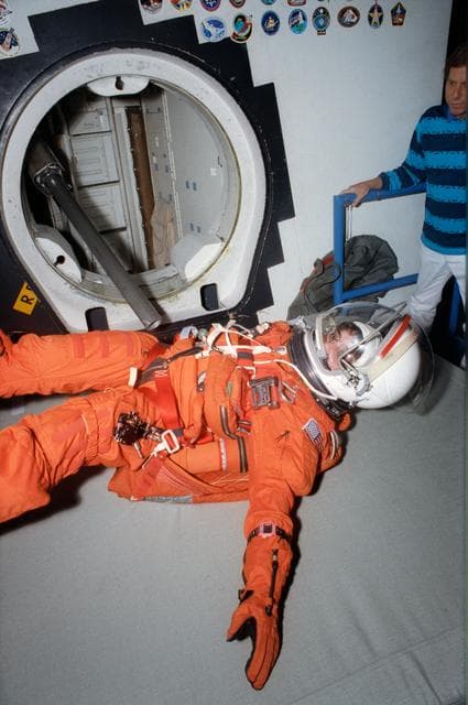 NASA image: STS-57 MS2 Sherlock, in LES, tumbles out JSC's CCT side hatch using CES pole