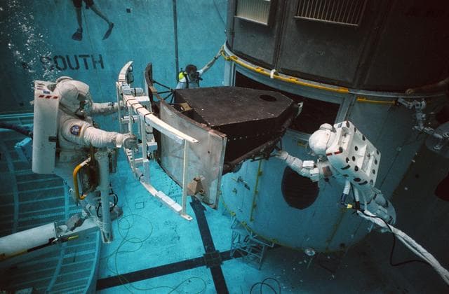 NASA image: STS-61 crewmembers in the WETF rehearsing for HST repair mission