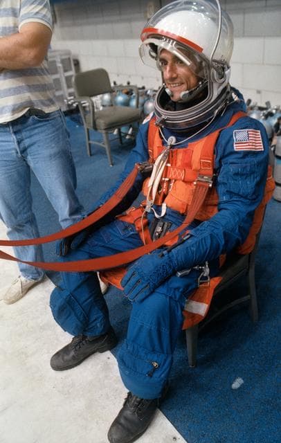 NASA image: STS-65 Mission Specialist Thomas sits on the poolside during bailout training