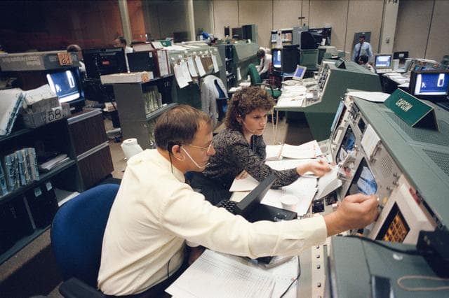 Astronauts Ross and Helms at CAPCOM station during STS-61 simulations