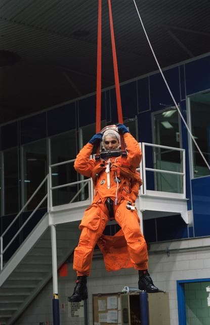 NASA image: Astronaut Sidney Gutierrez suspended by parachute during bailout training