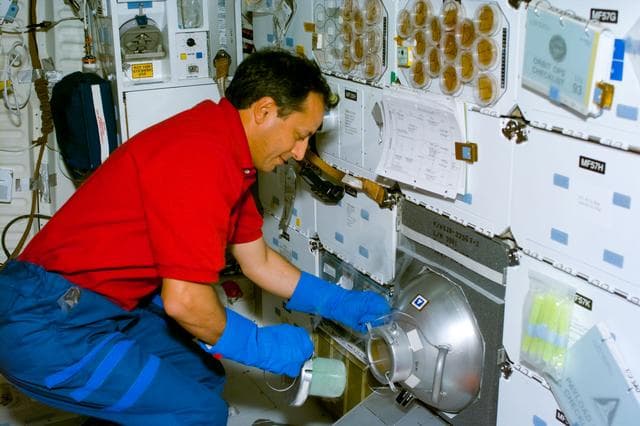BRIC-12,Mission Specialist Tognini handles the GN2 freezer.