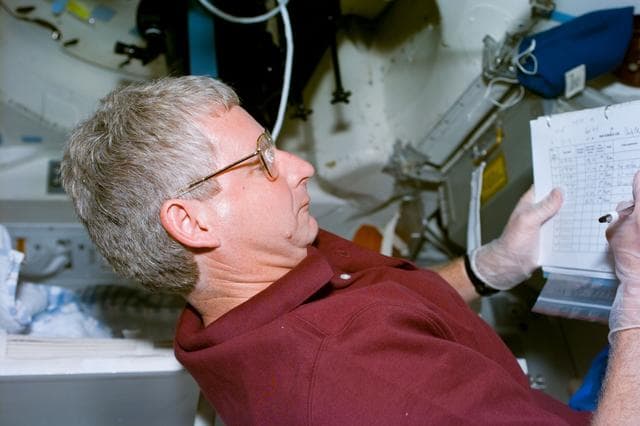 NASA image: SWUIS,Mission Specialist Hawley works with the experiment
