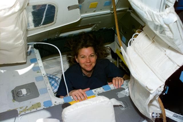 NASA image: Coleman moves through interdeck hatch into the flight deck