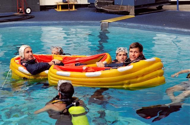 NASA image: Astronauts McMonagle and Brown float in one-man life rafts during training