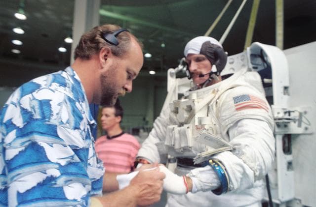NASA image: Astronaut Joseph Tanner is assisted into his EMU during training