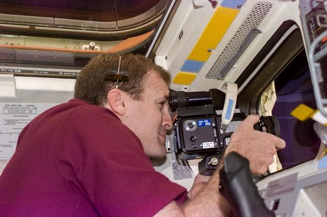 NASA image: Cmdr Halsell on flight deck with camera