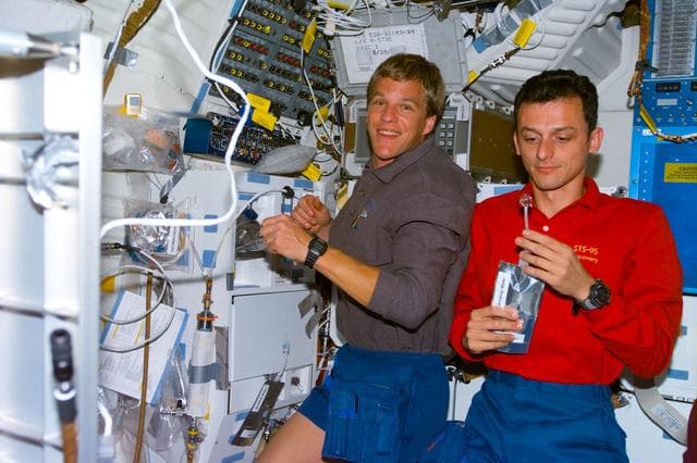 NASA image: Various views of the STS-95 crew on the Discovery's middeck