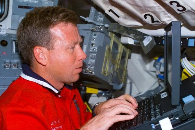 NASA image: Lindsey with laptop on flight deck