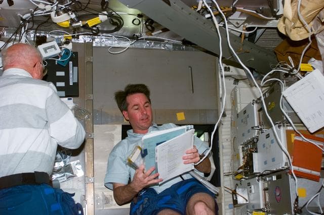 NASA image: Robinson and Glenn on middeck