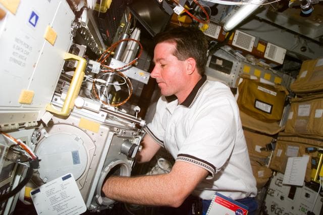NASA image: Robinson works with glovebox in the Spacehab module