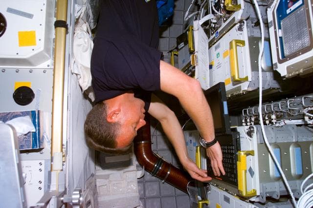 NASA image: Lindsey with lap top in the Spacehab