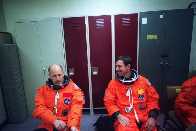 NASA image: STS-82 Suit-up for Post Insertion Training in Crew Compartment Trainer 2