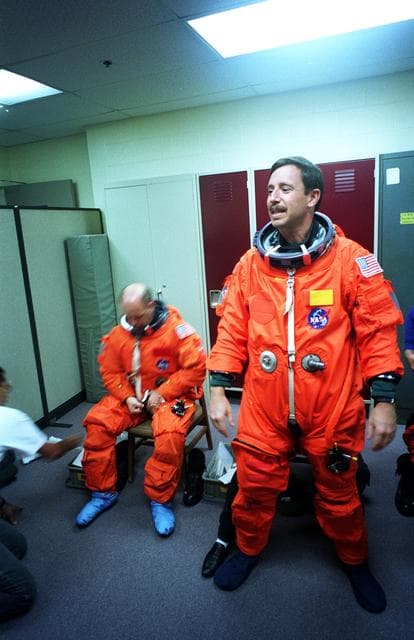 STS-82 Suit-up for Post Insertion Training in Crew Compartment Trainer 2