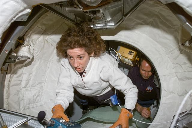 NASA image: Ellen Ochoa and Valeri Tokarev prior to entry into the Spacehab