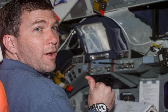 NASA image: Rick Husband gives thumbs-up from flight deck during rendezvous